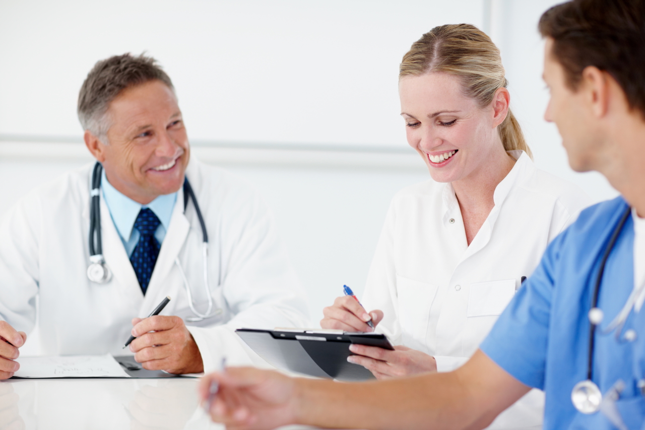 Three medical professionals having a catch up meeting together